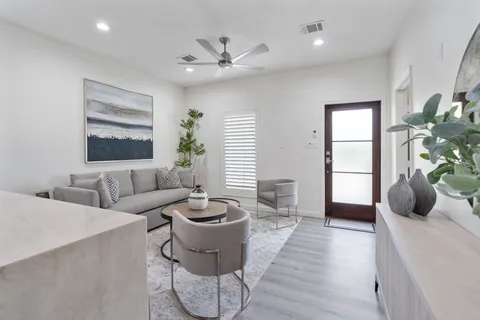 a living room with furniture and wooden floor