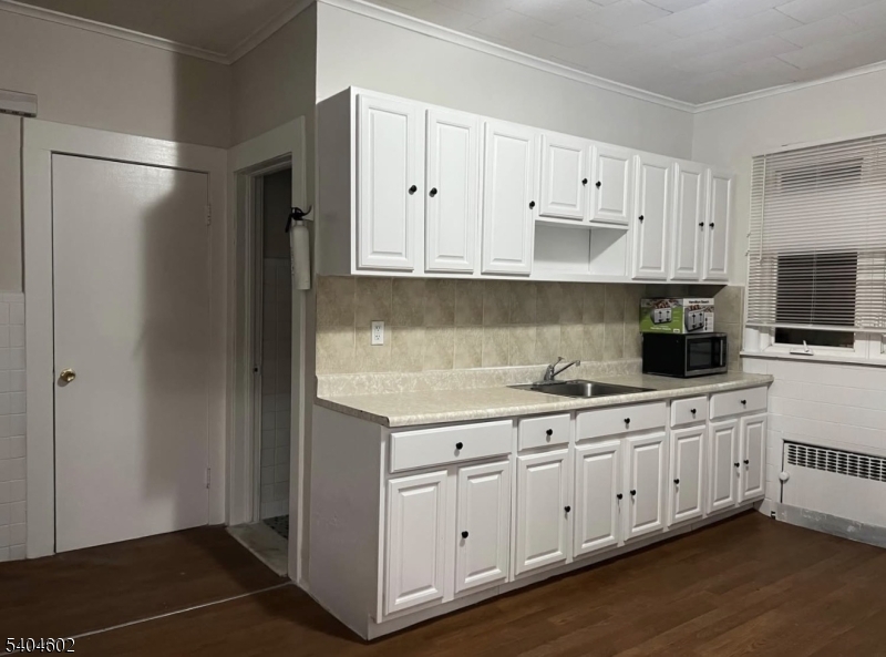 234 Christine Street, Unit 2F Elizabeth, NJ 07202 - Photo 6 of 11 a kitchen with white cabinets and sink