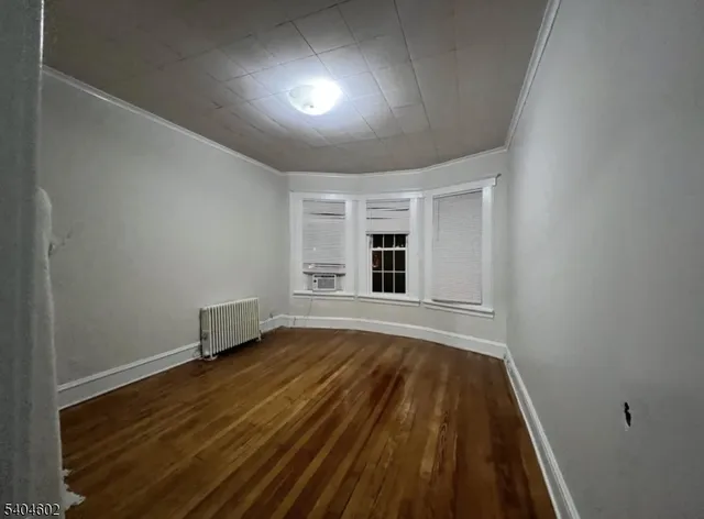 a view of hallway with wooden floor