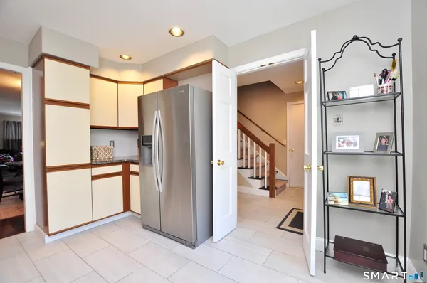 a kitchen with stainless steel appliances granite countertop a refrigerator and a stove