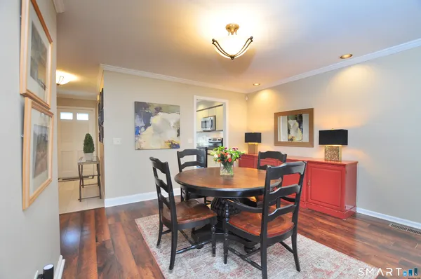 a view of a dining room with furniture and wooden floor