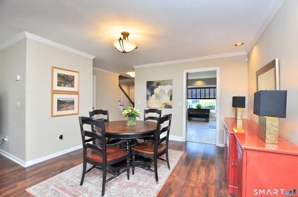 a view of a dining room with furniture and wooden floor
