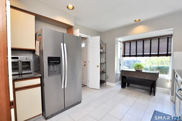 a kitchen that has a refrigerator and a window