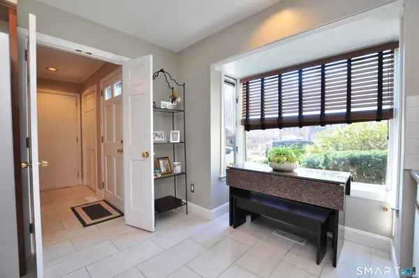 a sitting area with glass door and balcony