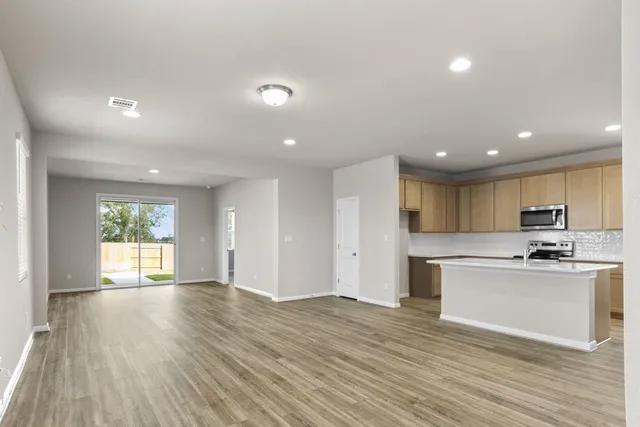 a view of kitchen with cabinets and wooden floor