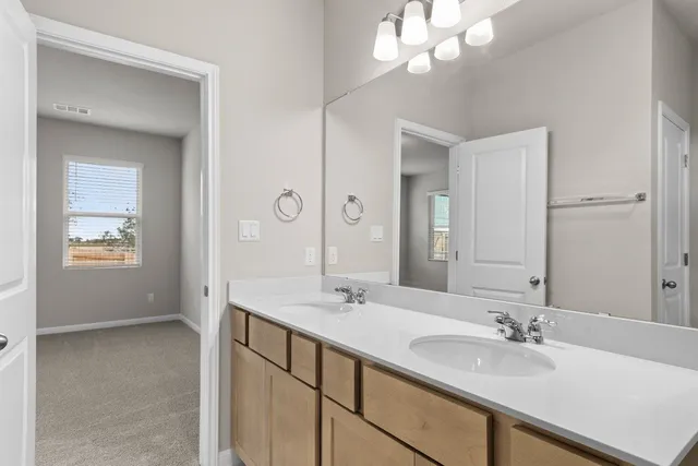 a bathroom with a sink a light fixture and a mirror