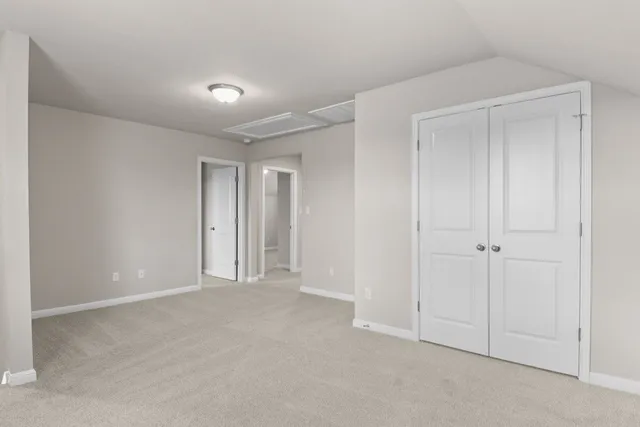 a view of an empty room and closet area