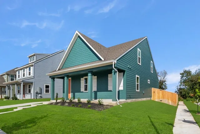 a backyard of a house with table and chairs