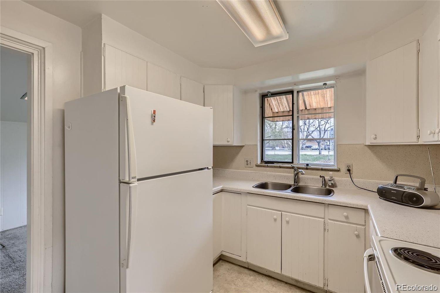 411 Quebec Street Denver, CO 80220 - Photo 11 of 31 a white refrigerator freezer sitting inside of a kitchen