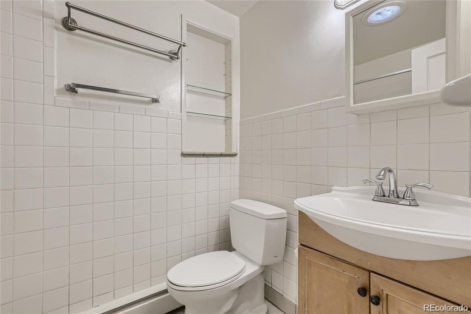 411 Quebec Street Denver, CO 80220 - Photo 23 of 31 a bathroom with a toilet sink and shower