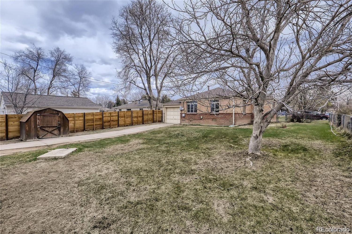411 Quebec Street Denver, CO 80220 - Photo 27 of 31 a view of a yard with a house and a large tree