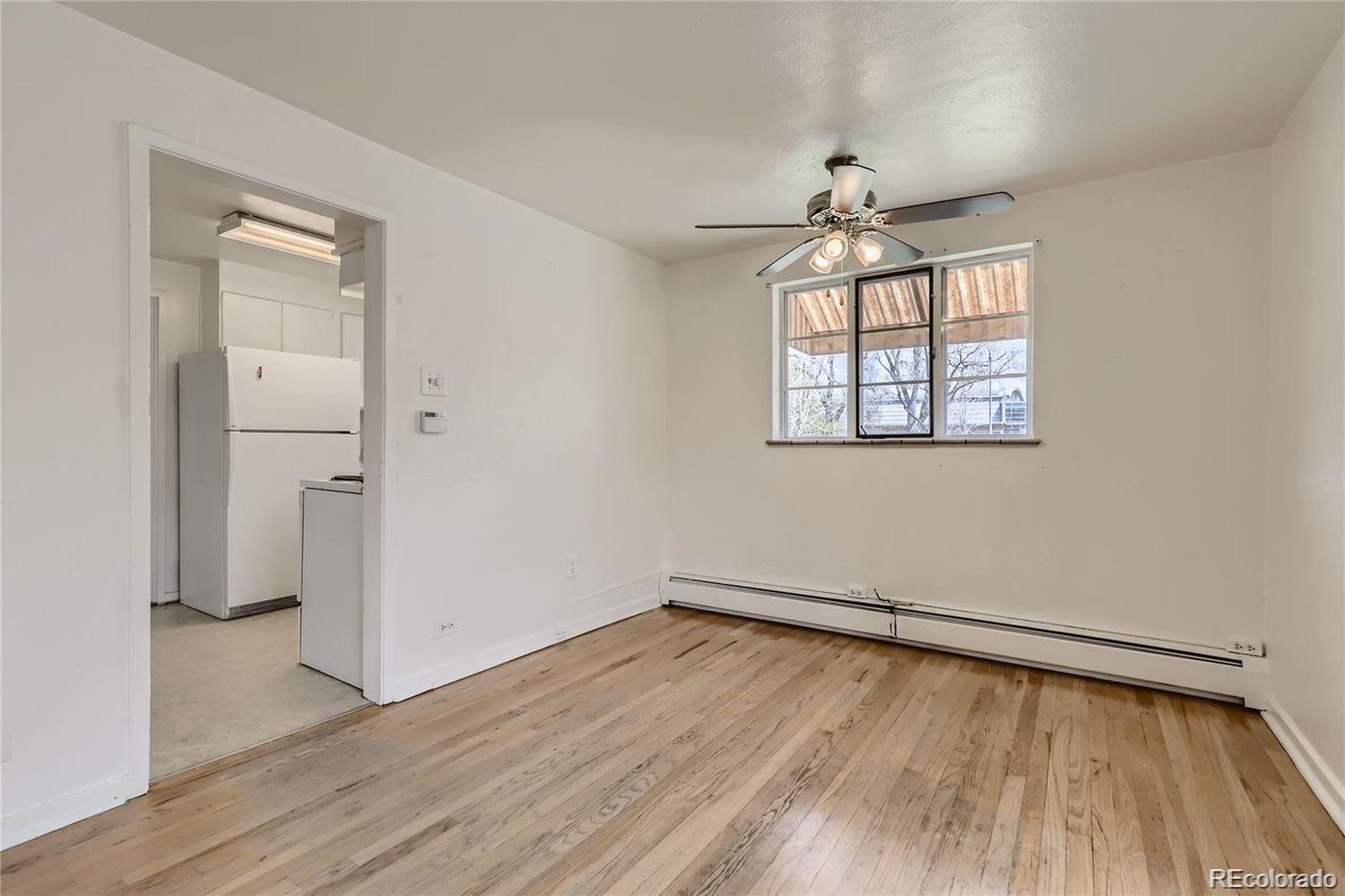 411 Quebec Street Denver, CO 80220 - Photo 8 of 31 wooden floor in an empty room with a window