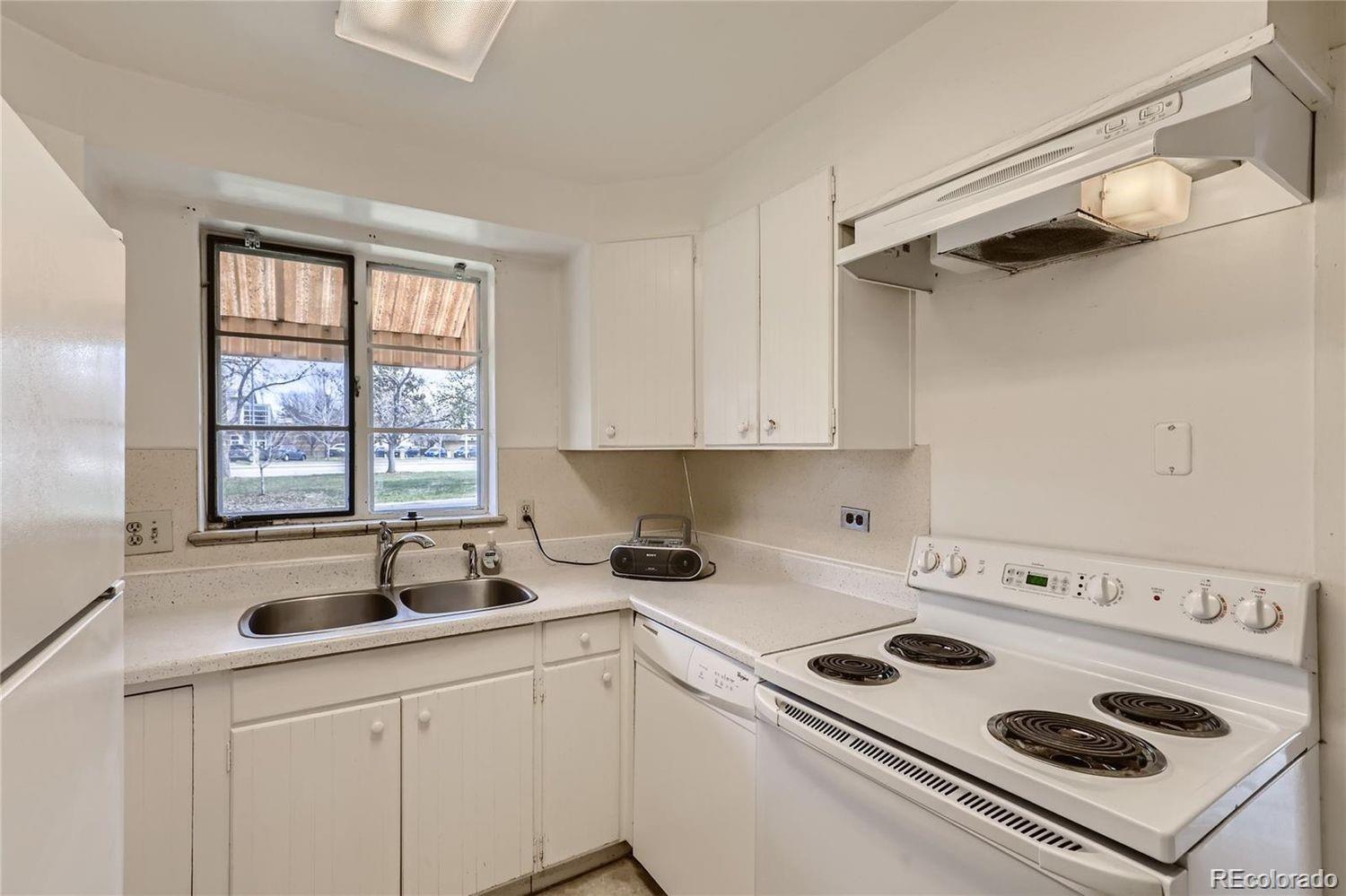 411 Quebec Street Denver, CO 80220 - Photo 9 of 31 a kitchen with a sink a stove and cabinets