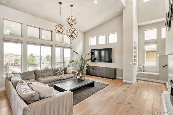 a living room with furniture and a floor to ceiling window