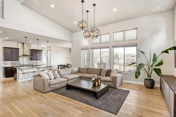 a living room with furniture kitchen view and a fireplace