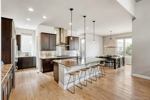 a large kitchen with stainless steel appliances kitchen island granite countertop a large counter top and stove