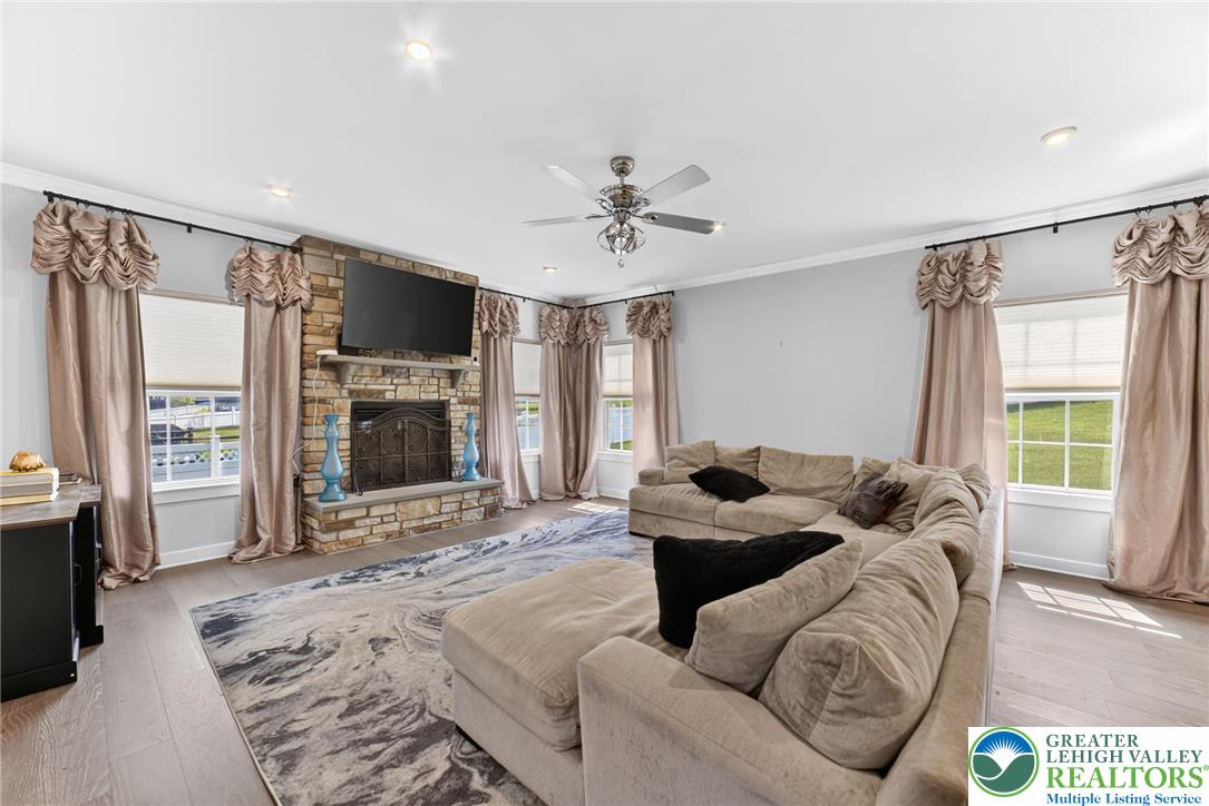 3952 Orth Street Bethlehem, PA 18020 - Photo 4 of 60 A comforting living area with a stone fireplace, sleek hardwood flooring, and ample seating invites relaxation.