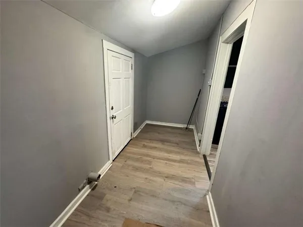 a view of a room with a ceiling fan and a window
