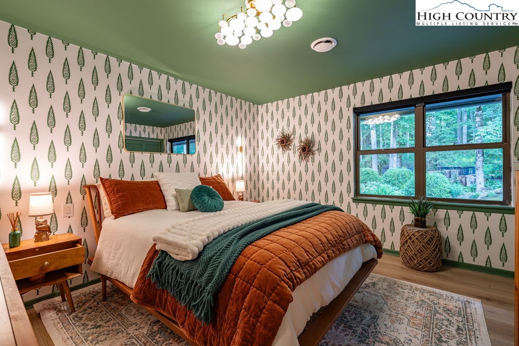 102 Ridge Drive Linville, NC 28646 - Photo 35 of 48 a bedroom with a large bed and a large window