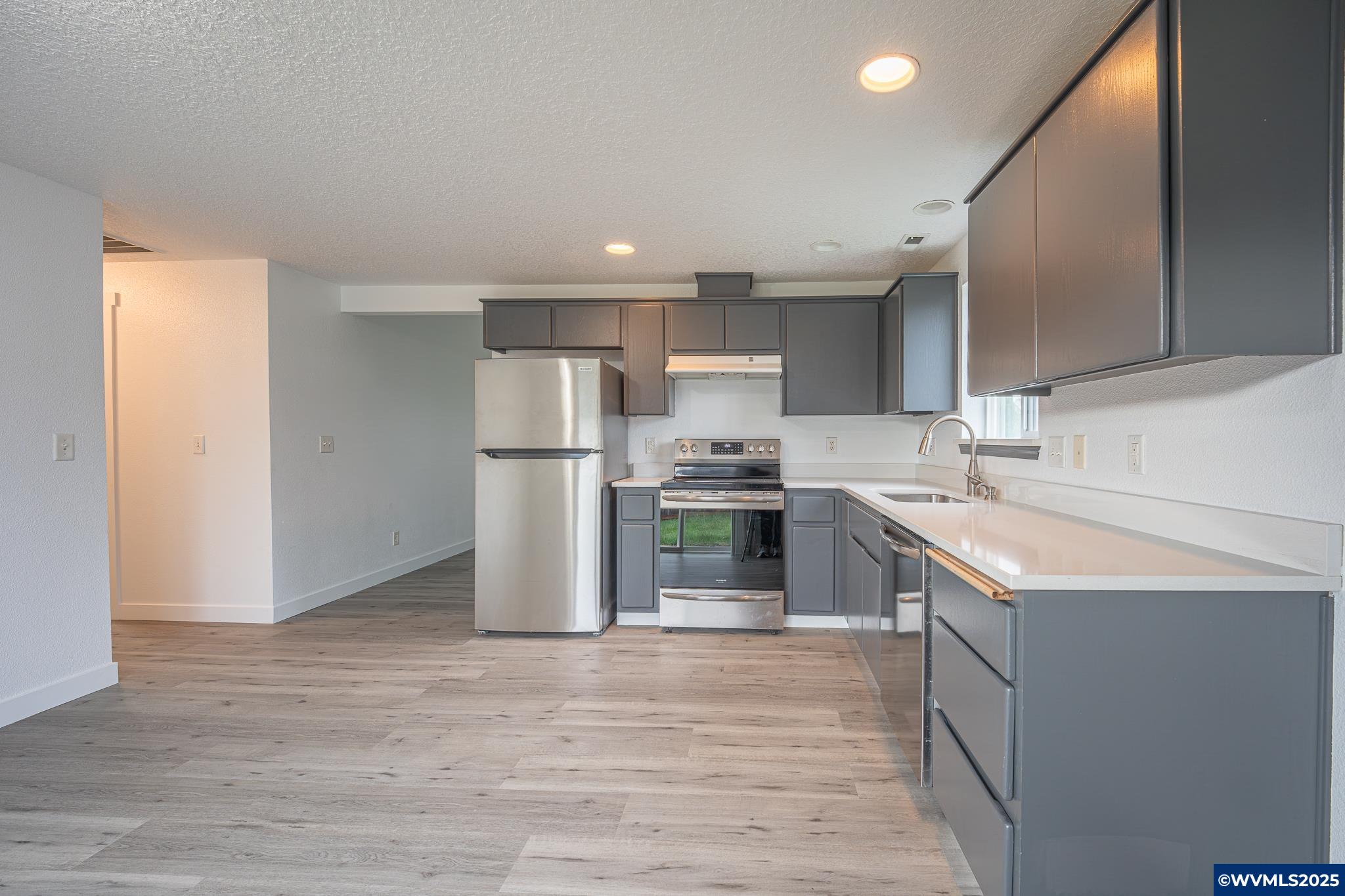 1467 South 7th Street Independence, OR 97351 - Photo 10 of 31 a kitchen with a sink refrigerator and a oven