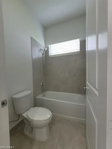 a bathroom with a toilet and a bath tub