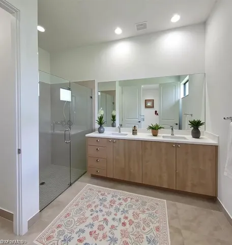 a bathroom with a sink mirror and a shower