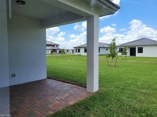 a view of a porch with a table and chairs