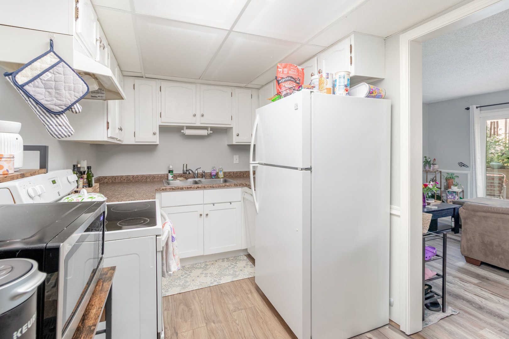 3325 Kirchoff Road, Unit 3C Rolling Meadows, IL 60008 - Photo 5 of 13 a kitchen with refrigerator cabinets and wooden floor