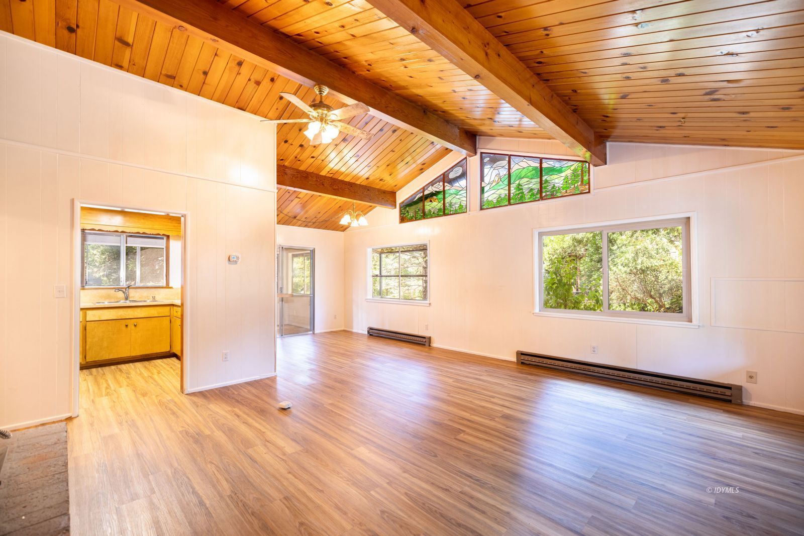 25201 Palomar Road Idyllwild, CA 92549 - Photo 6 of 18 a view of an empty room with wooden floor and a window