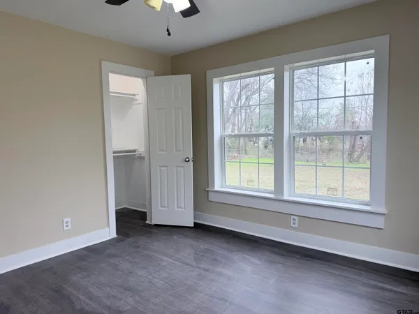 an empty room with a empty space and windows