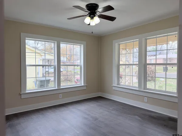 a view of a livingroom with a ceiling fan and window