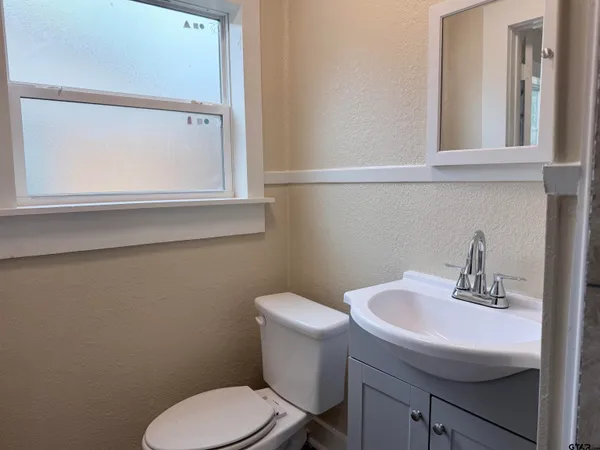 a bathroom with a sink and mirror