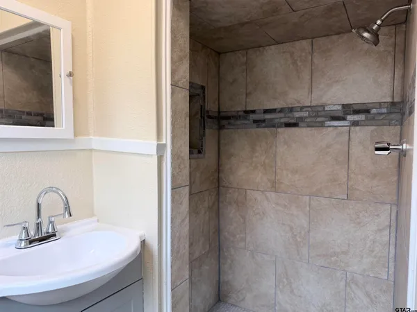 a bathroom with a sink a mirror and a toilet