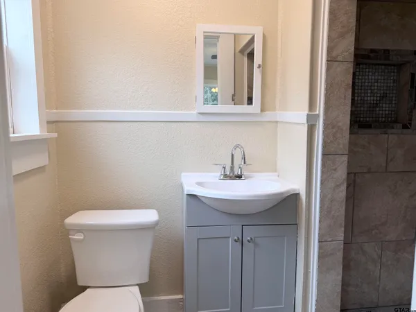 a bathroom with a shower and a bath tub