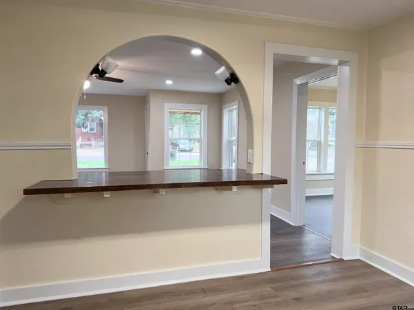 an entryway with wooden floor and cabinet