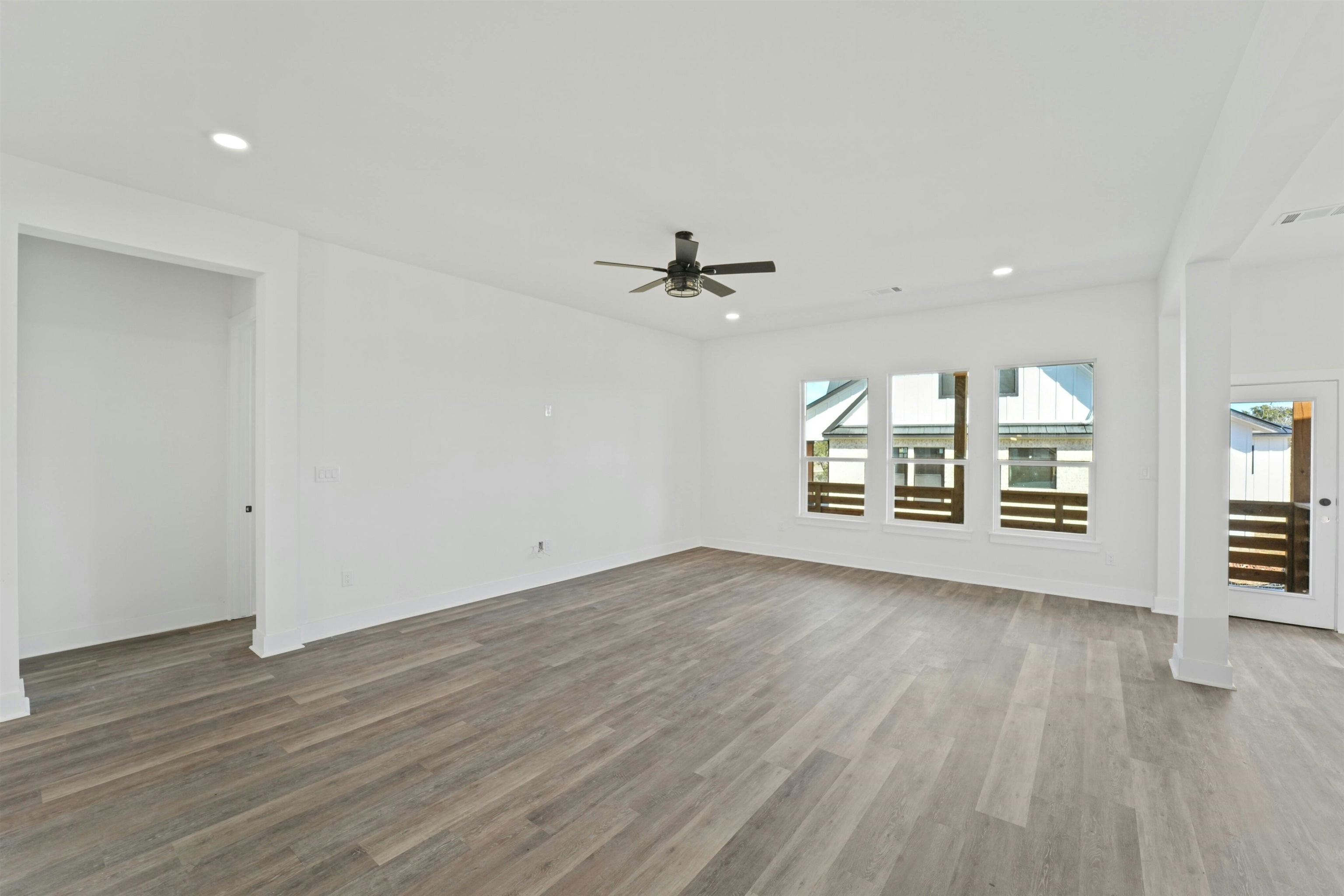 100 Up There Horseshoe Bay, TX 78657 - Photo 12 of 28 an empty room with wooden floor fan and windows