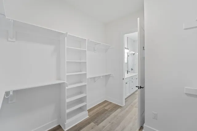 a view of walk in closet with empty racks