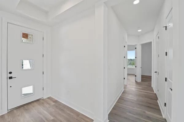 a view of a hallway with wooden floor