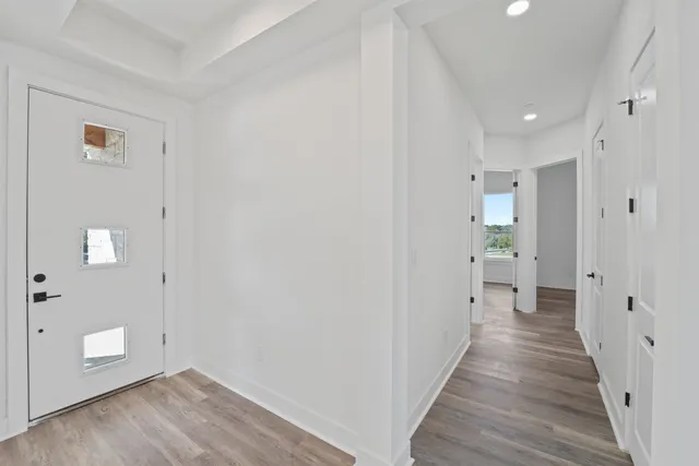 a view of a hallway with wooden floor