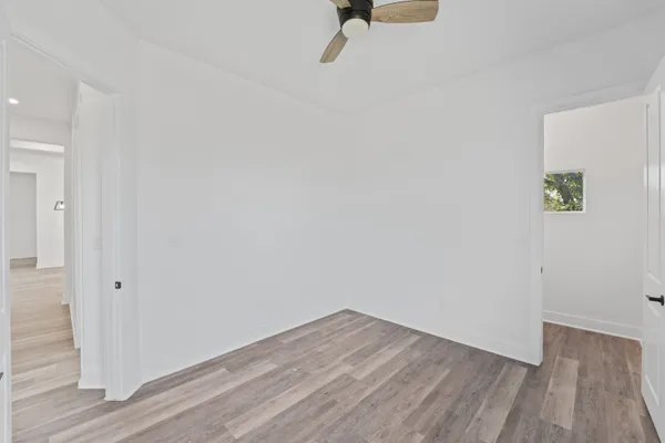 a view of a room with wooden floor