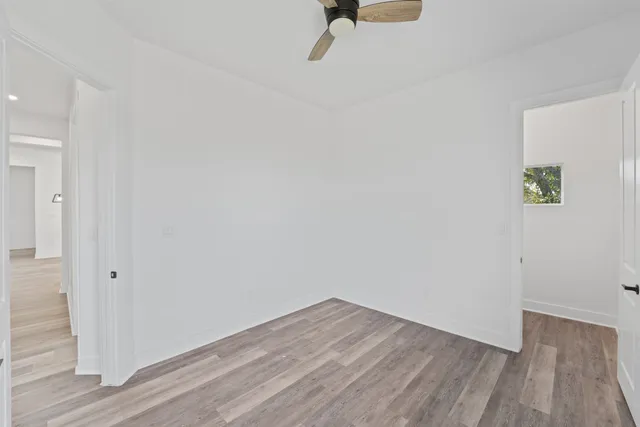 a view of a room with wooden floor