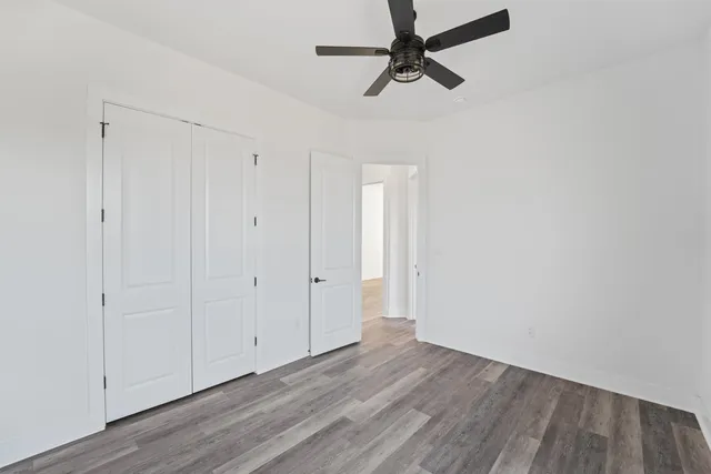 a view of a room with wooden floor