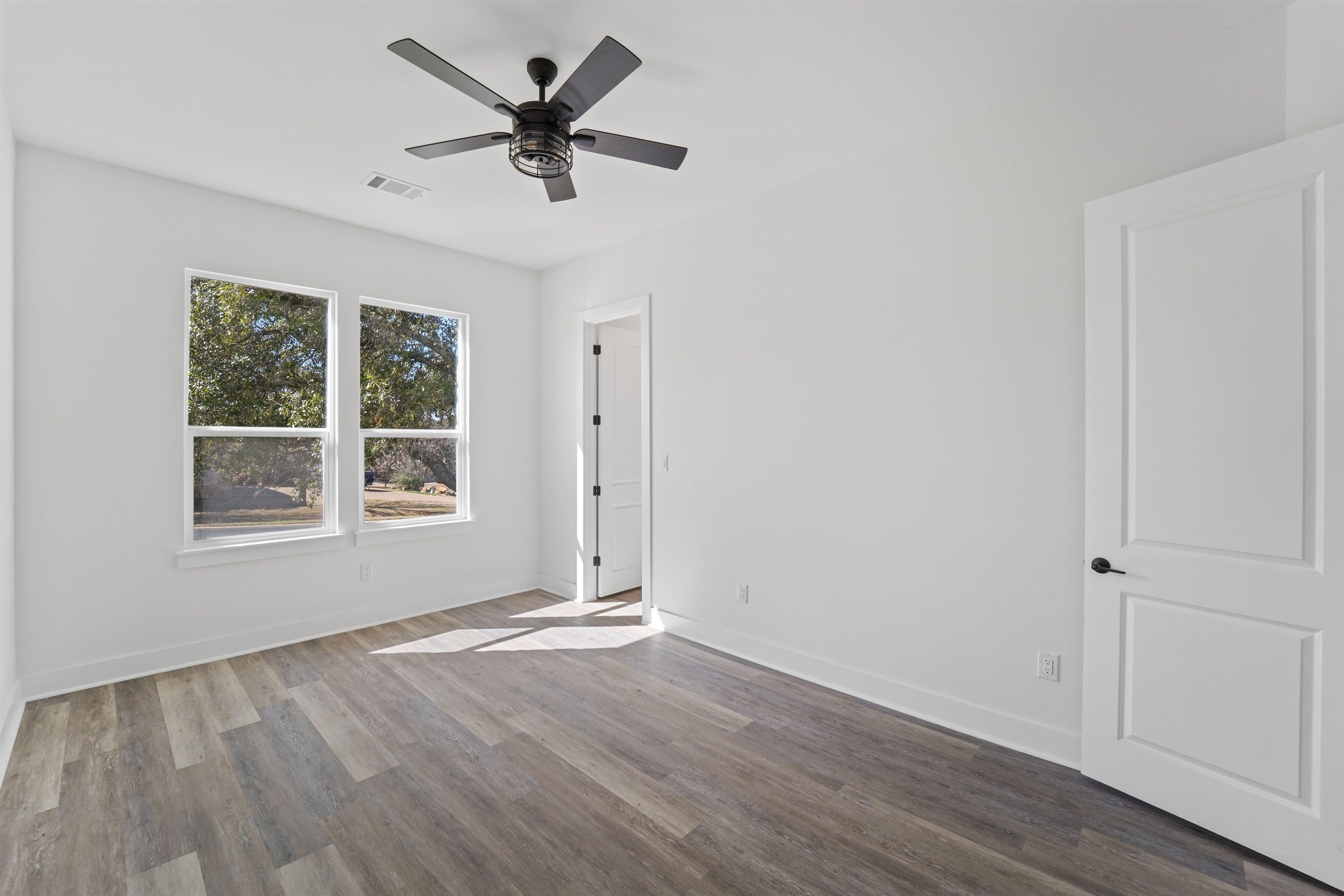 100 Up There Horseshoe Bay, TX 78657 - Photo 25 of 28 an empty room with wooden floor and windows