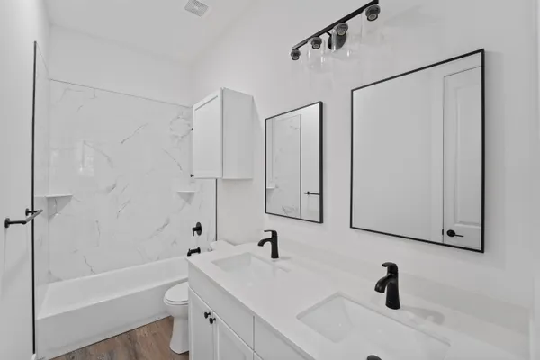 a bathroom with a tub sink and mirror