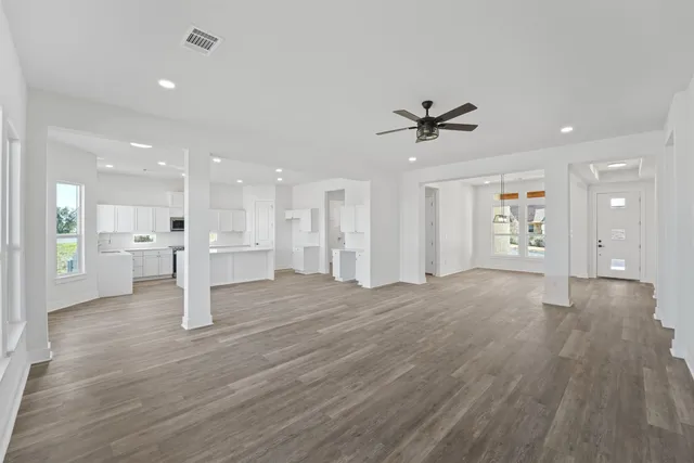 a view of an empty room with a kitchen