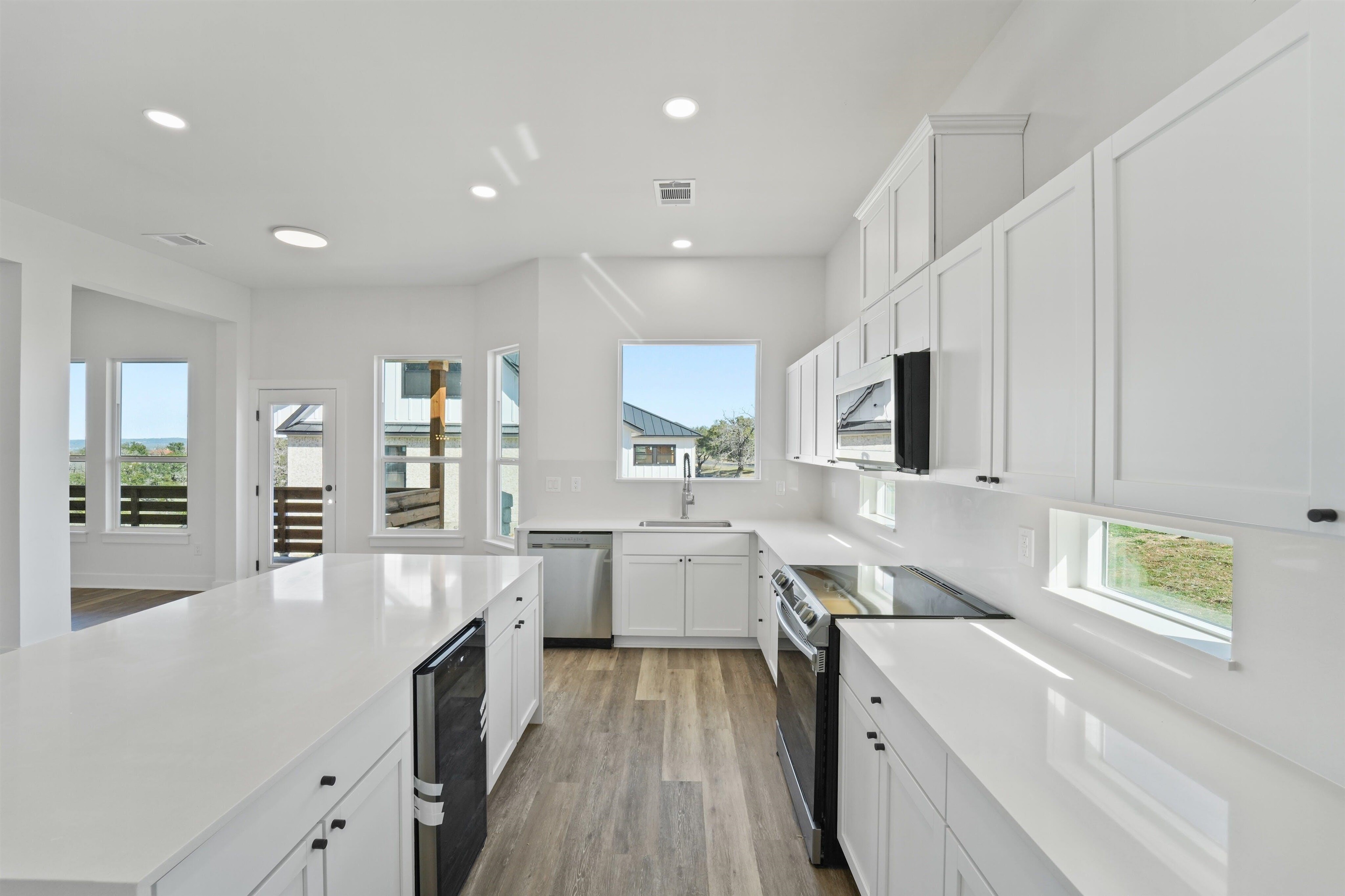 100 Up There Horseshoe Bay, TX 78657 - Photo 8 of 28 a large kitchen with stainless steel appliances lots of counter space and wooden floor