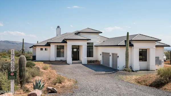a view of a house with a yard and garage