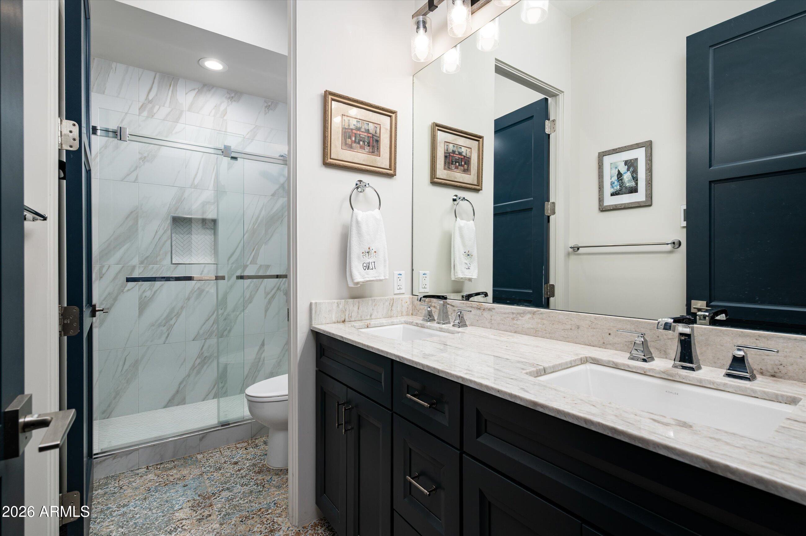 17439 East Wildcat Drive Rio Verde, AZ 85263 - Photo 13 of 25 a bathroom with a double vanity sink a toilet and shower