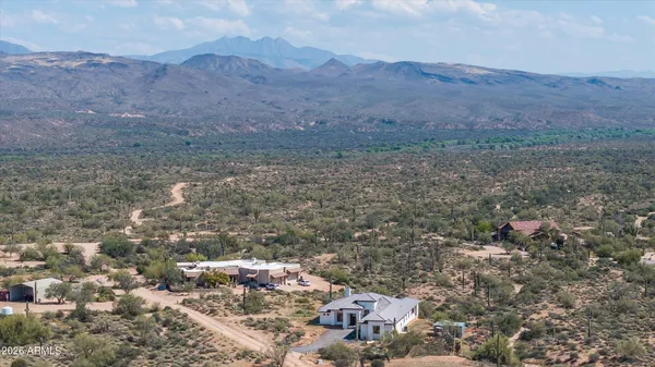 an aerial view of house with yard and mountain view