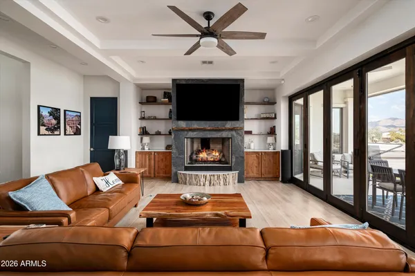 a living room with furniture fireplace and flat screen tv